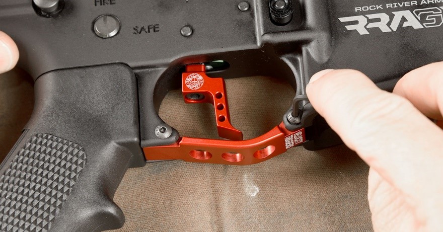 The MPC trigger guard uses three supplied screws to secure to the receiver—...