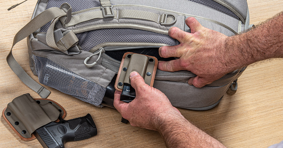 Backpack with hidden online gun compartment