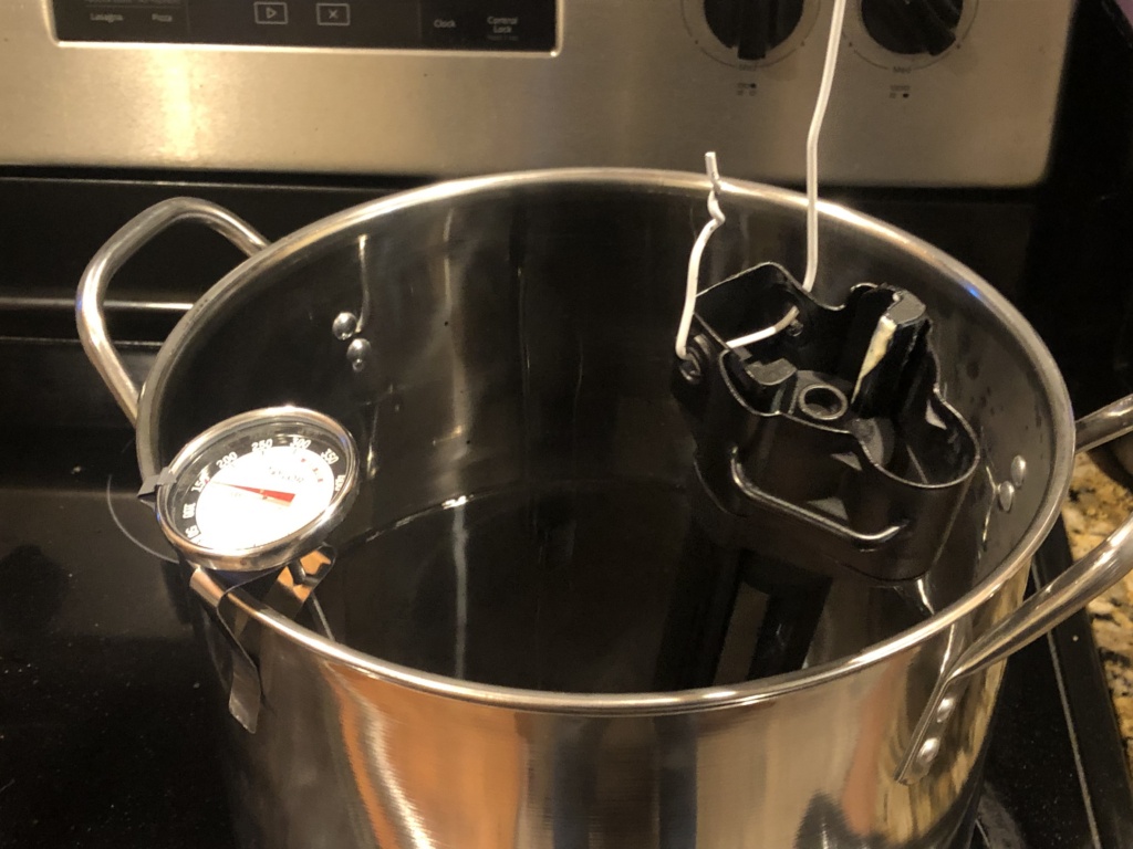 I used an especially strong mix of black Rit dye, which should be brought up to, or over, the 140 degree operating temperature. Hotter might be better, but I wasn’t interested in melting anything. Assuming the dye will do to your hands when it did when it splashed onto my jeans, you’ll want to wear gloves.