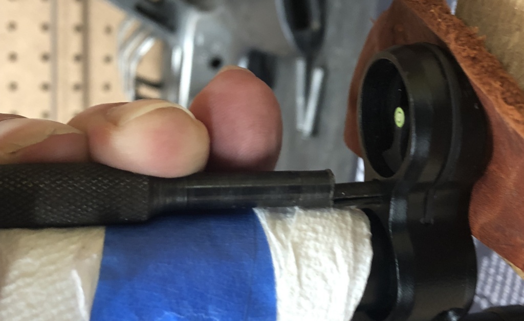 Field-stripping the gun will leave you with less to balance while you work. It’s very easy to mar the cocking tube and front sight ring. Wrapping something protective around the tube and using a leather-padded block of wood as a bench block will dramatically reduce the risk of damage. Here, I’m using a large, flat-ended punch to re-seat the roll pin.