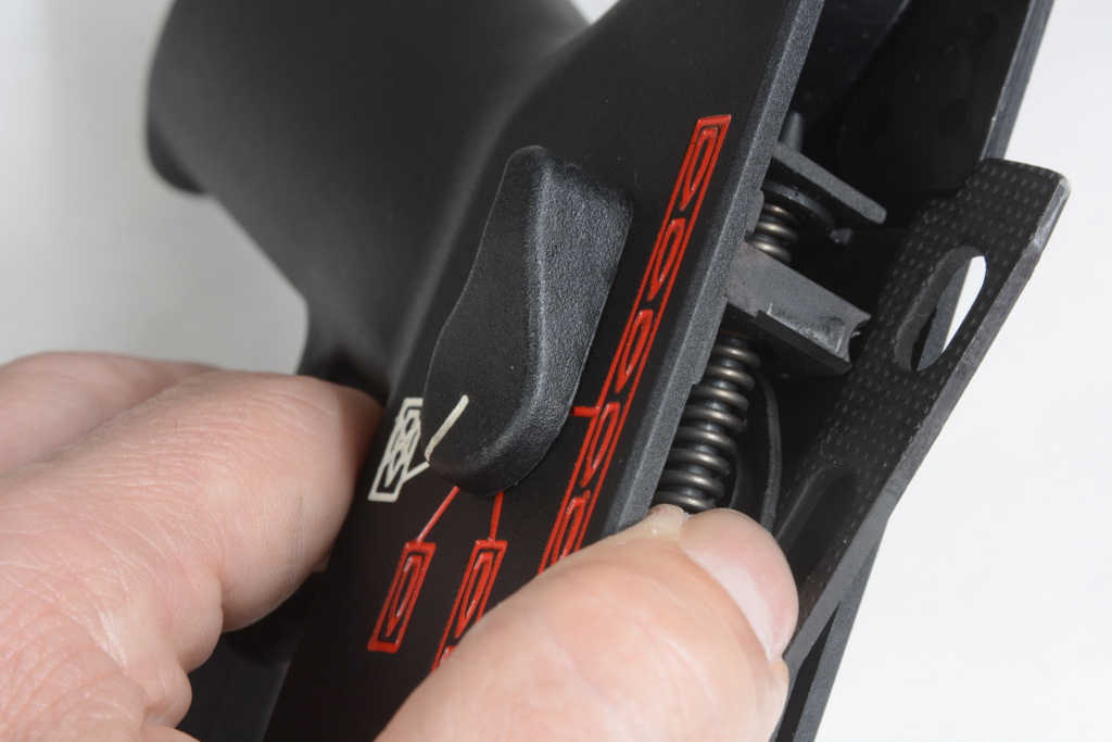 There’s a forward-facing lever that must be pushed downwards to rotate the tab out of the way and allow the right selector lever to be removed.