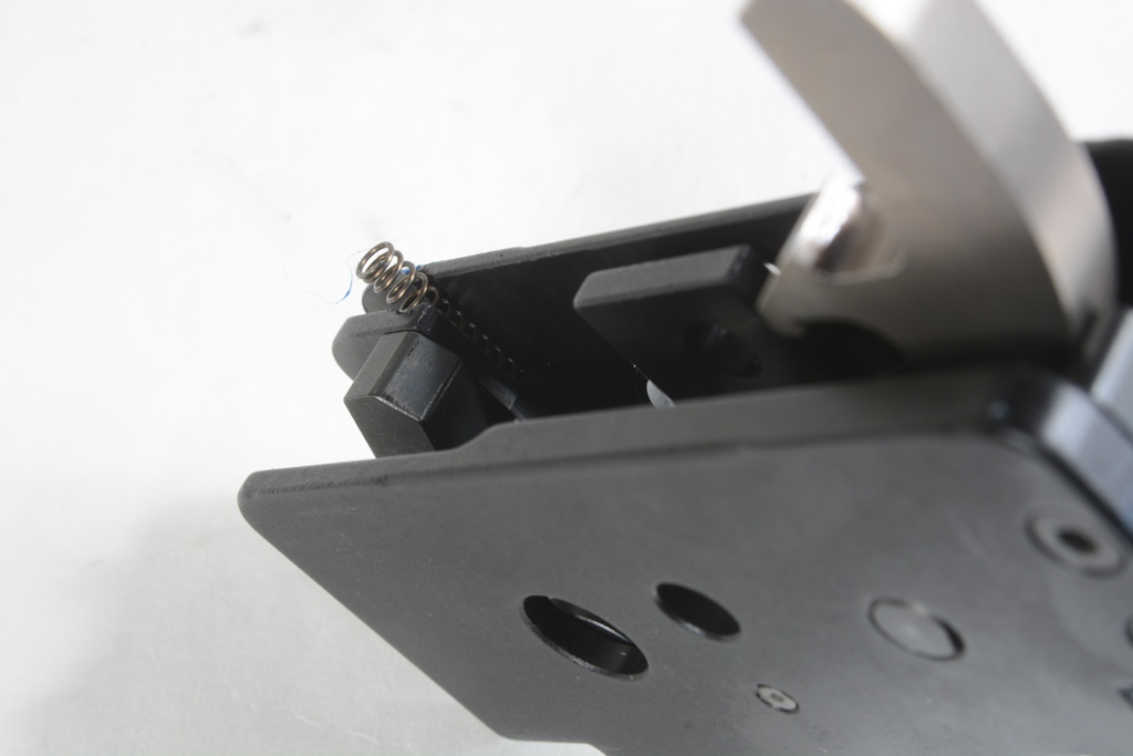 Insert Tootsie Pop in mouth, and slip the ejector spring straight down into its seat in the trigger pack, where it pushes up on the rear of the ejector. A little light grease on it, the ejector and its pin is a good idea.